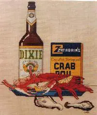 A bottle next to a plate of crawfish
